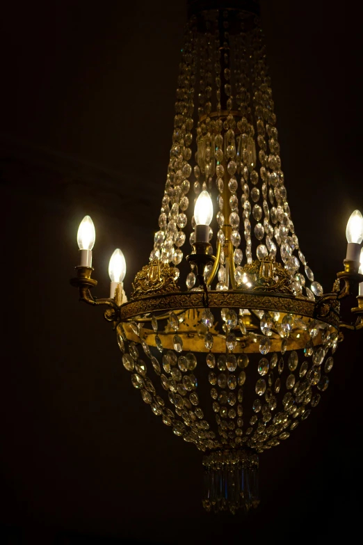 a large chandelier hanging from a ceiling with light bulbs