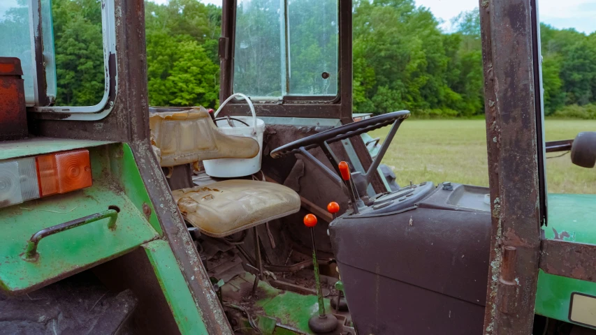 the interior of an old green tractor is shown
