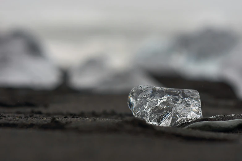 an image of a broken glass piece on the beach