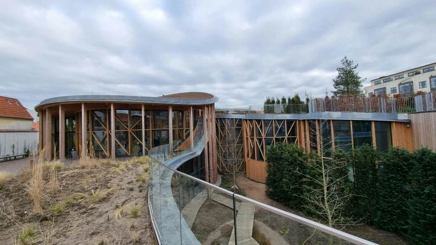 a walkway near some buildings on a hill