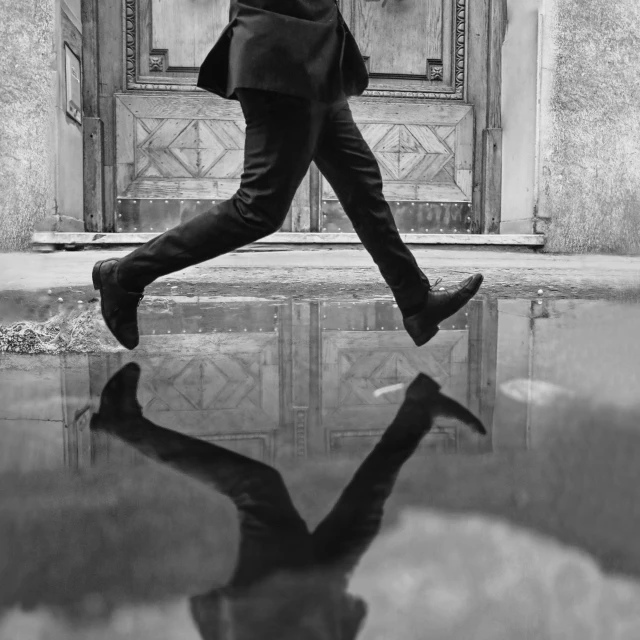 black and white pograph of a man holding an umbrella