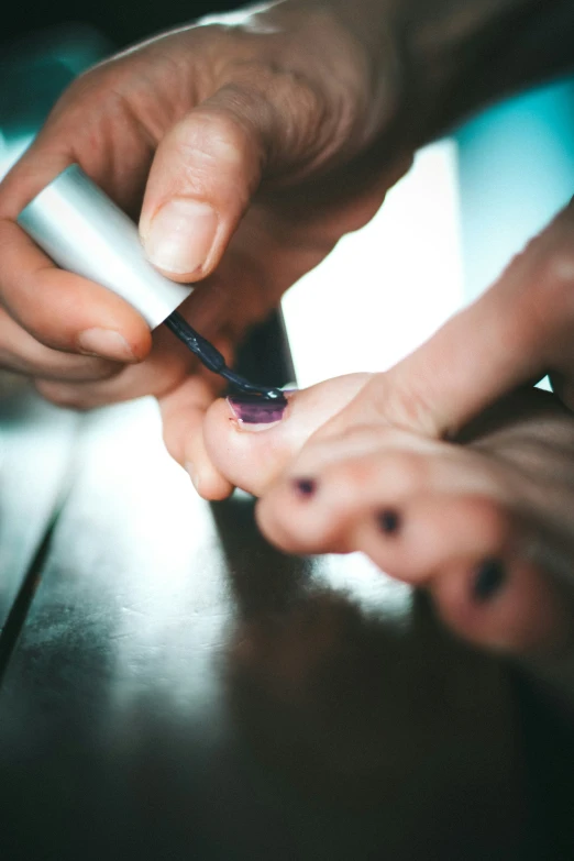 two people are operating a small electronic device