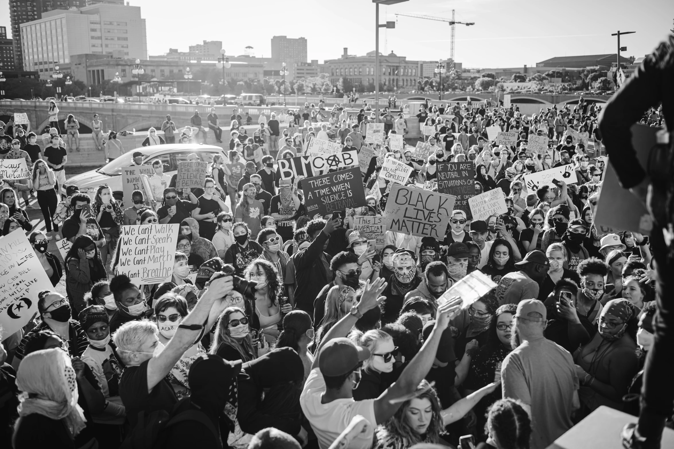 the black and white po shows the large crowd of people with signs