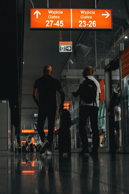 a couple of people with luggage in the dark