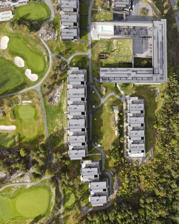 an aerial po of a building complex in a golf course