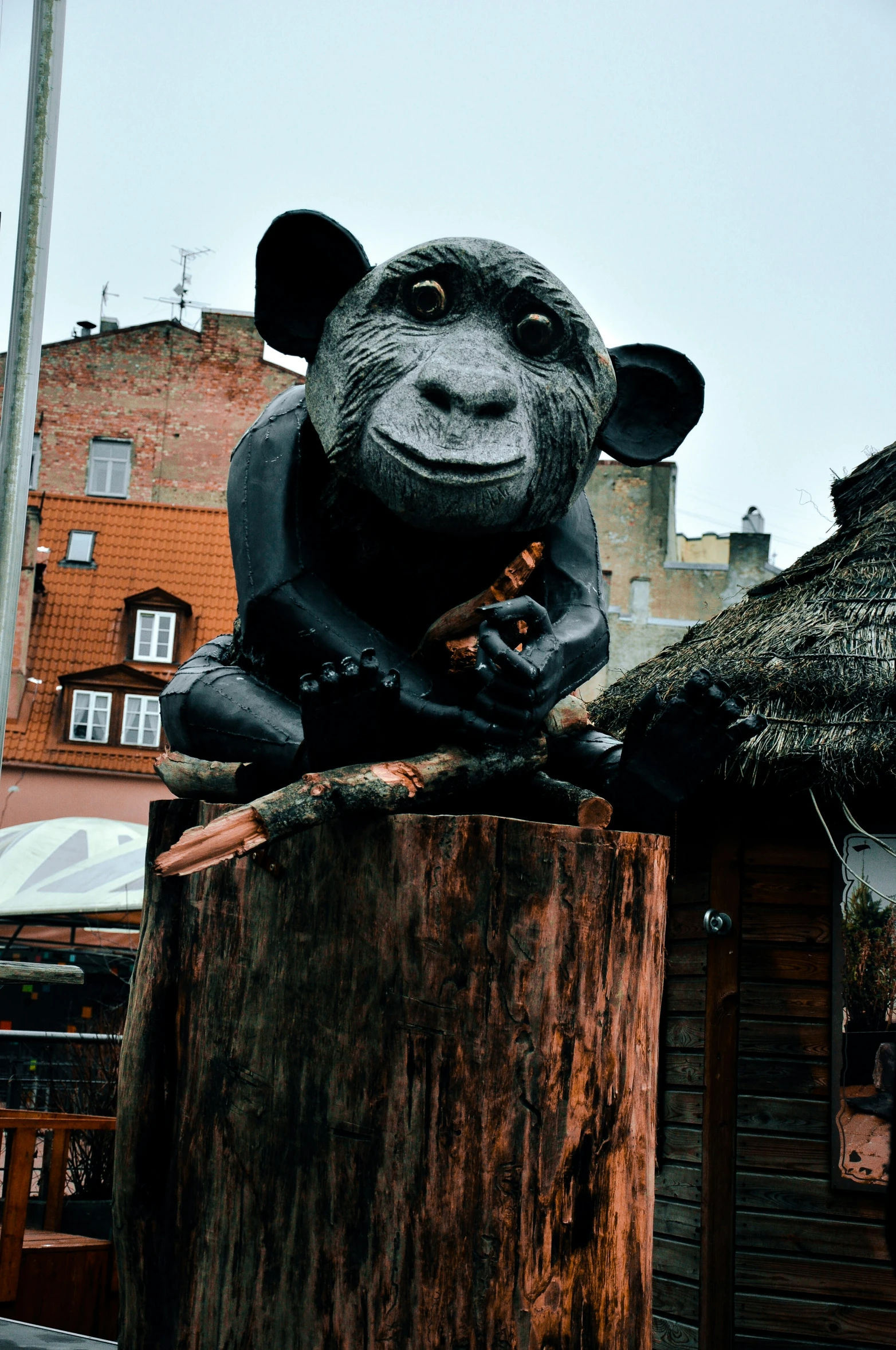 a sculpture of a monkey made to look like it is sitting on a log