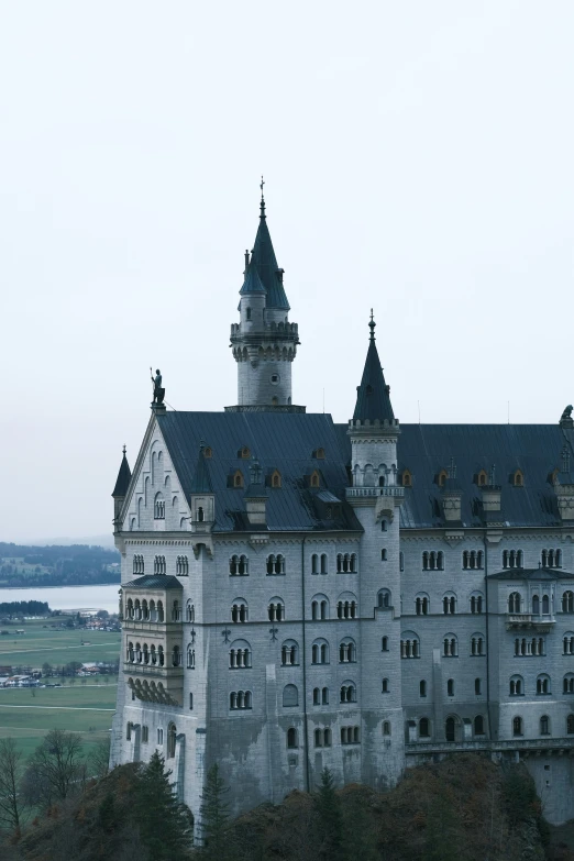 the side of a large castle with some towers on it