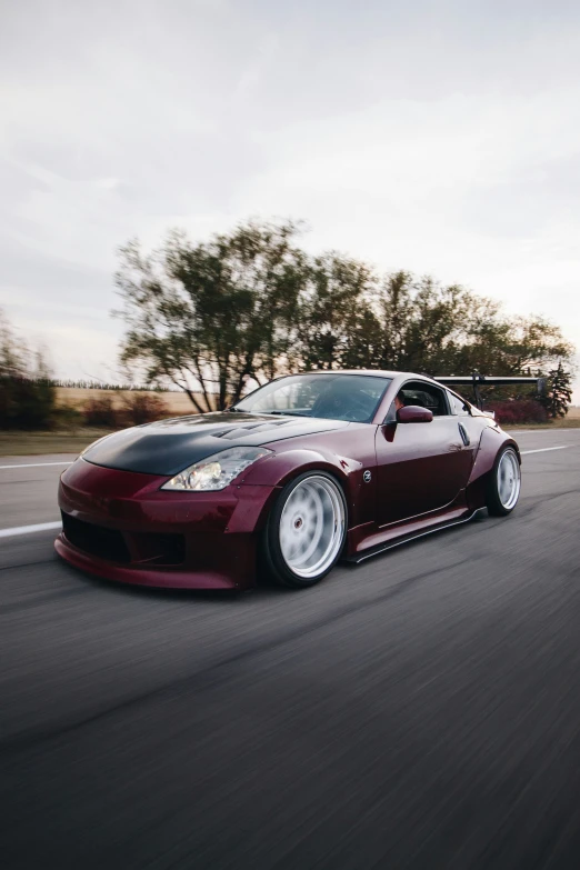 a red sports car driving on a road