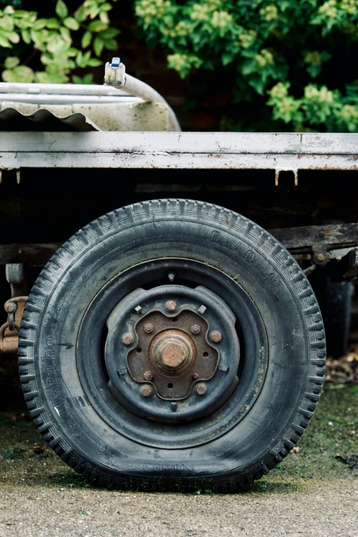 a metal flatbed truck's flat tire sits by itself