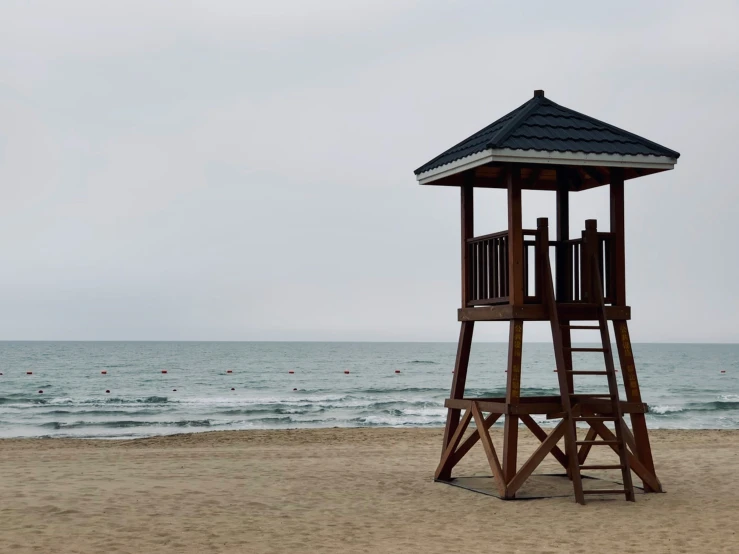 a life guard tower at the beach is empty