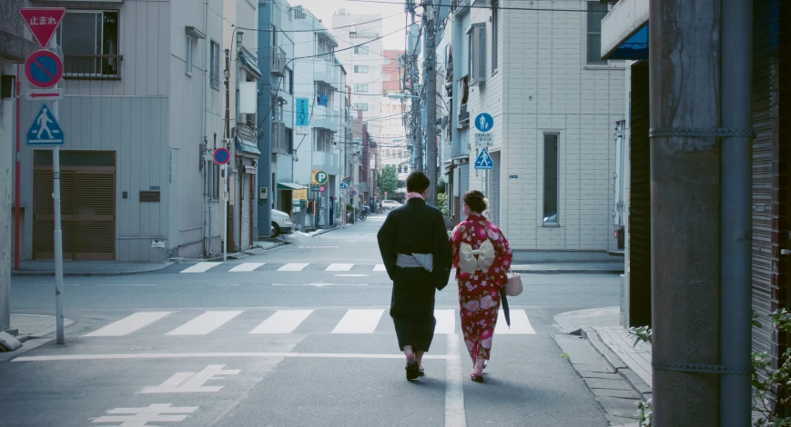 a couple of people walking down a street