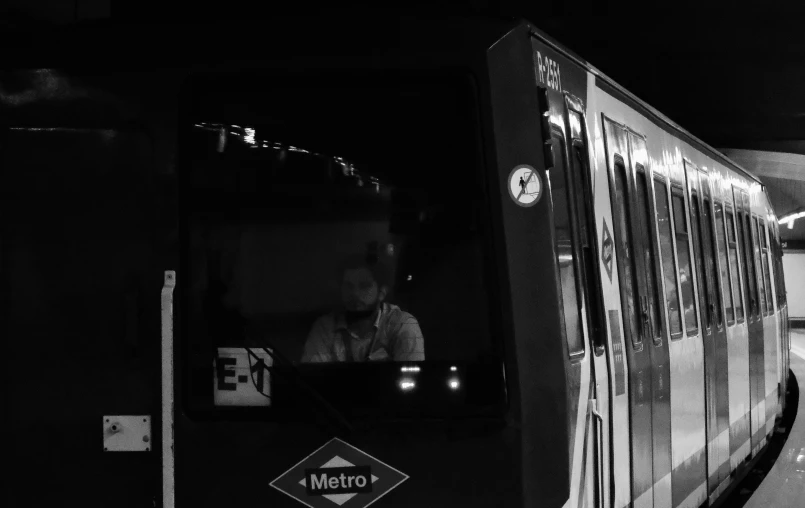 a passenger train at a station at night