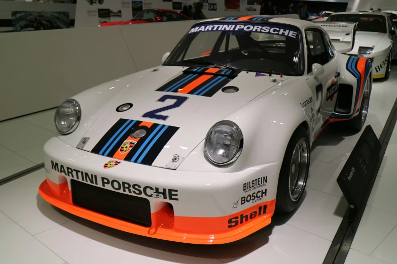 an older porsche gt2 race car parked in a showroom