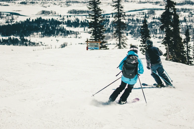 a pair of skiers are going up a mountain