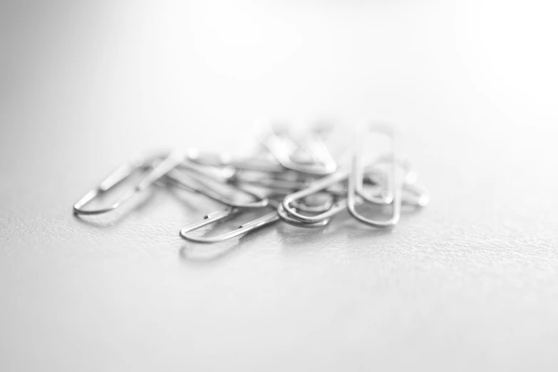 many small metal clips with scissors in them
