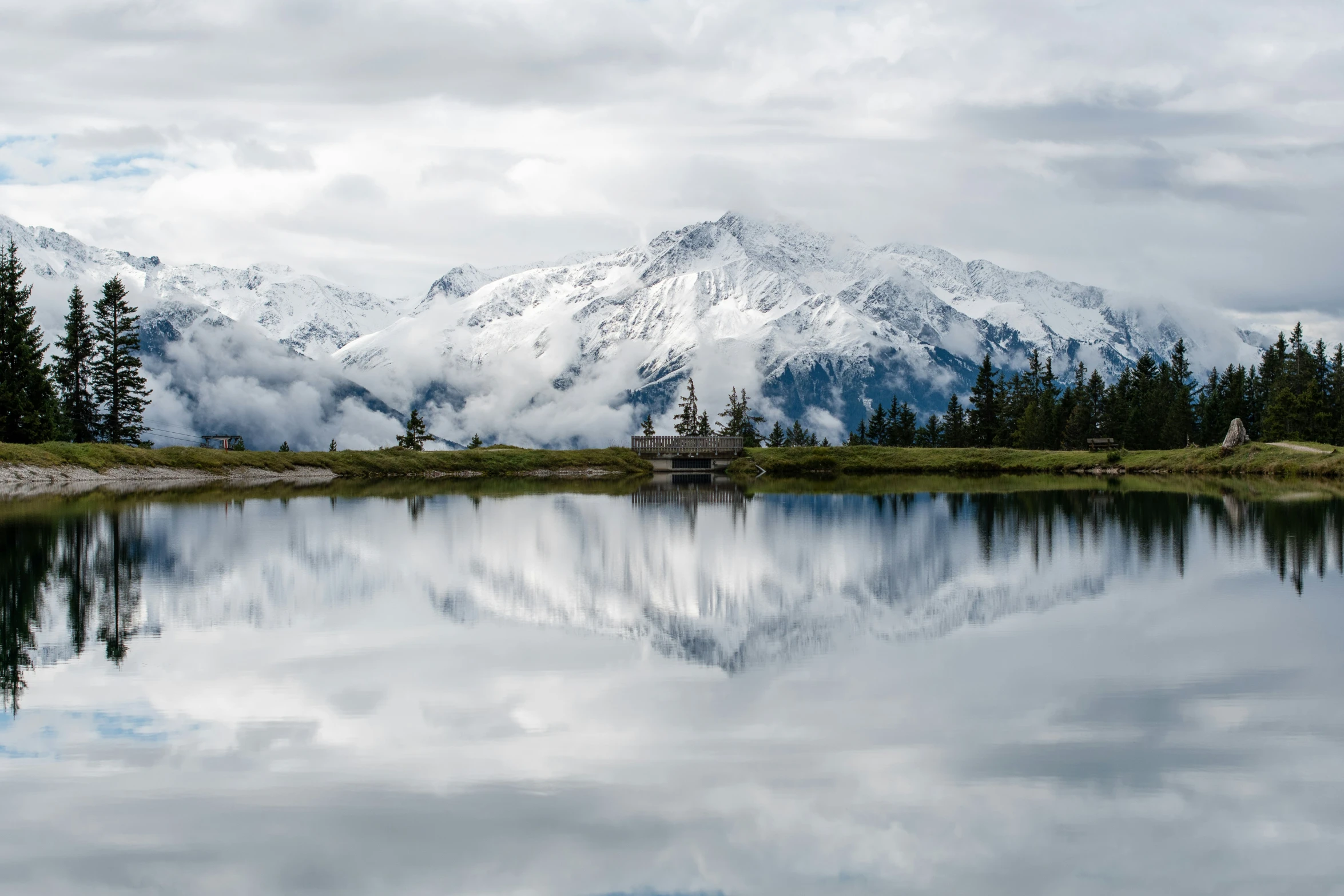 a mountain range with mountains and trees in the distance