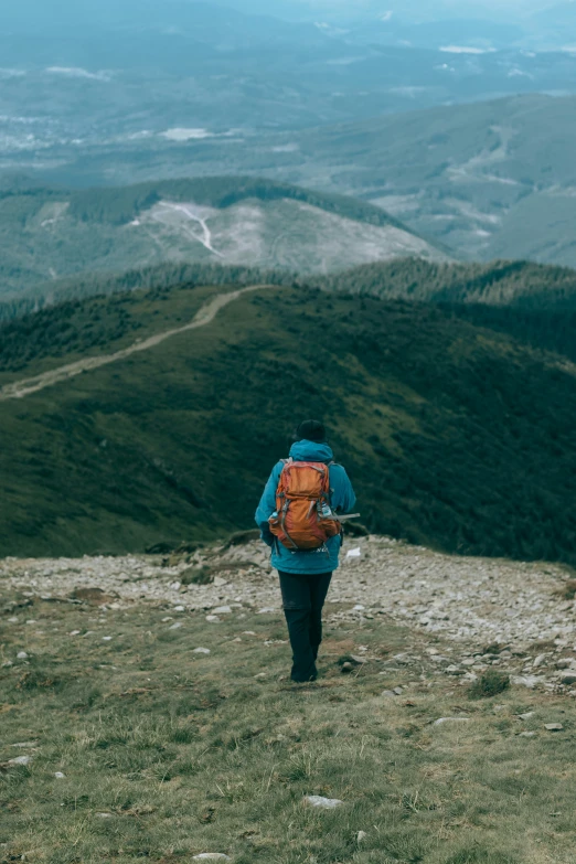 a person with a backpack is hiking the mountain