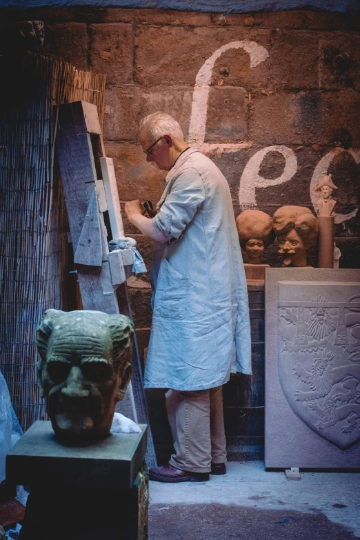 a man painting on a wall with a painting easel