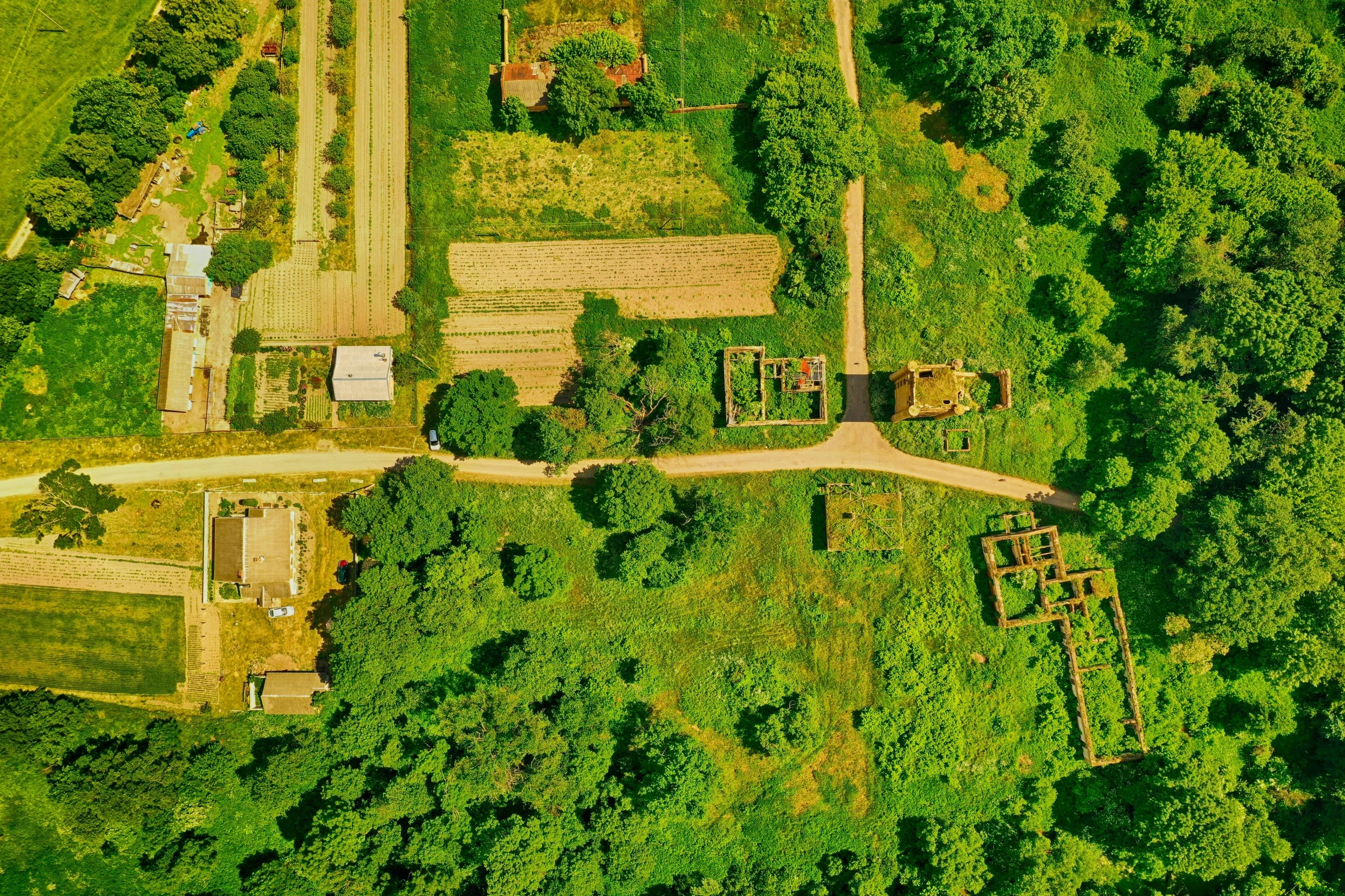 an aerial view of a garden and path in the country