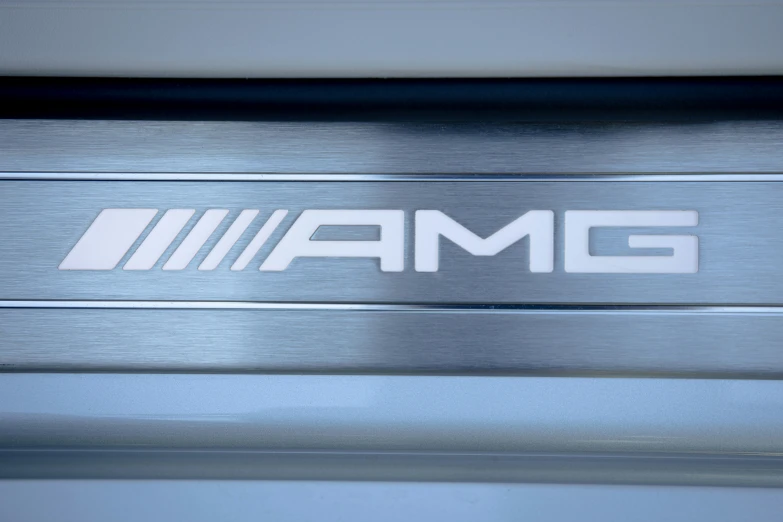 an amg emblem on the side of a silver vehicle