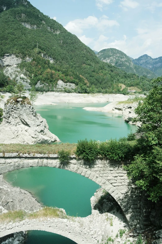 two water lakes in a mountain valley surrounded by greenery