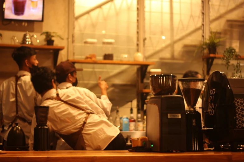 a person sitting next to a counter near a tv