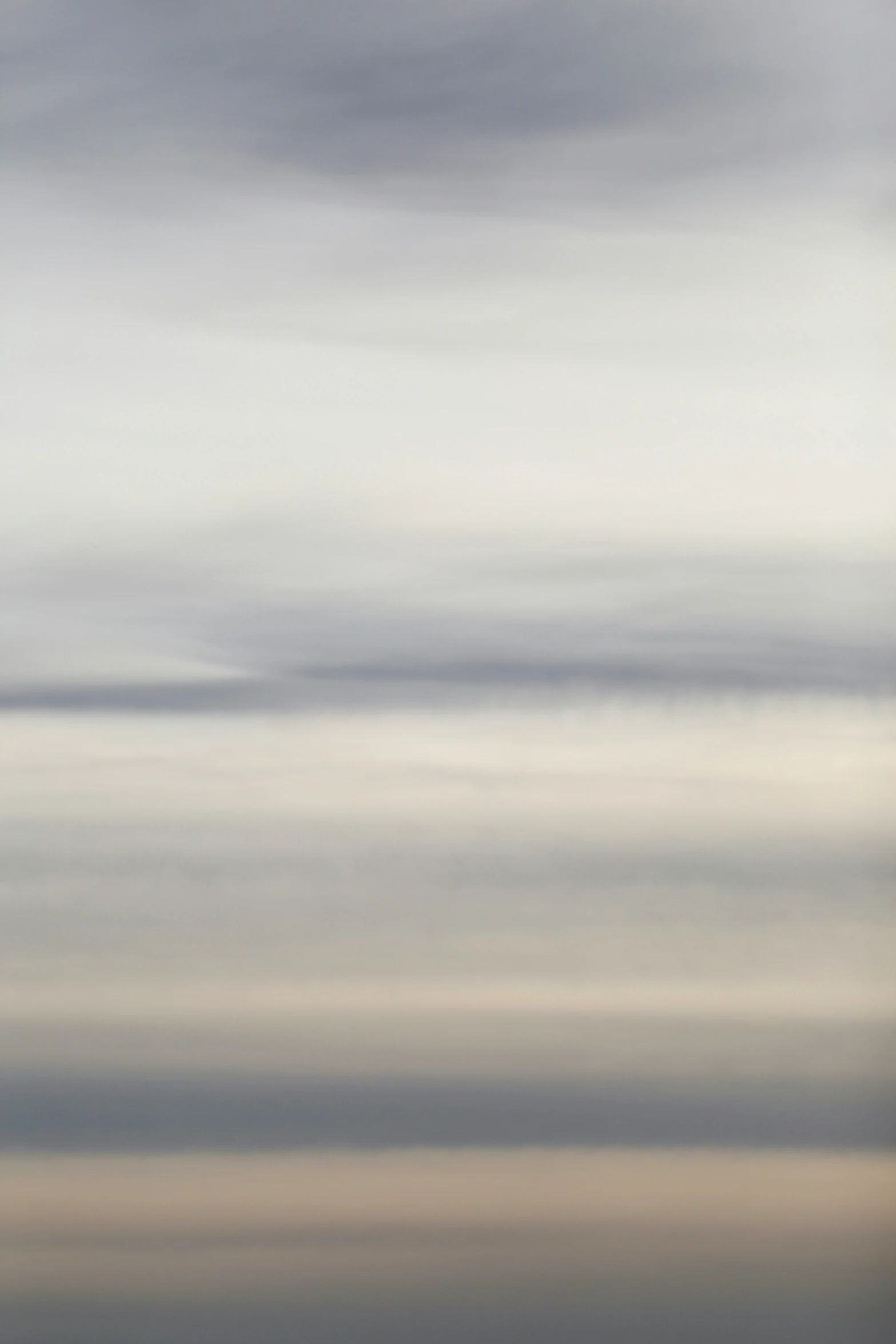 a view of a cloudy sky with some kites in the foreground