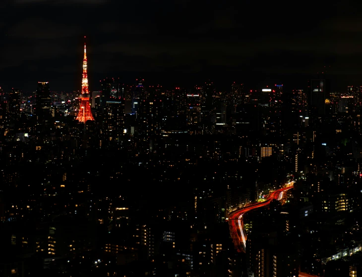 the city lights are red and yellow as seen from a high viewpoint