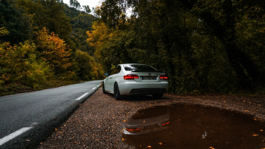 a car is parked next to the side of the road