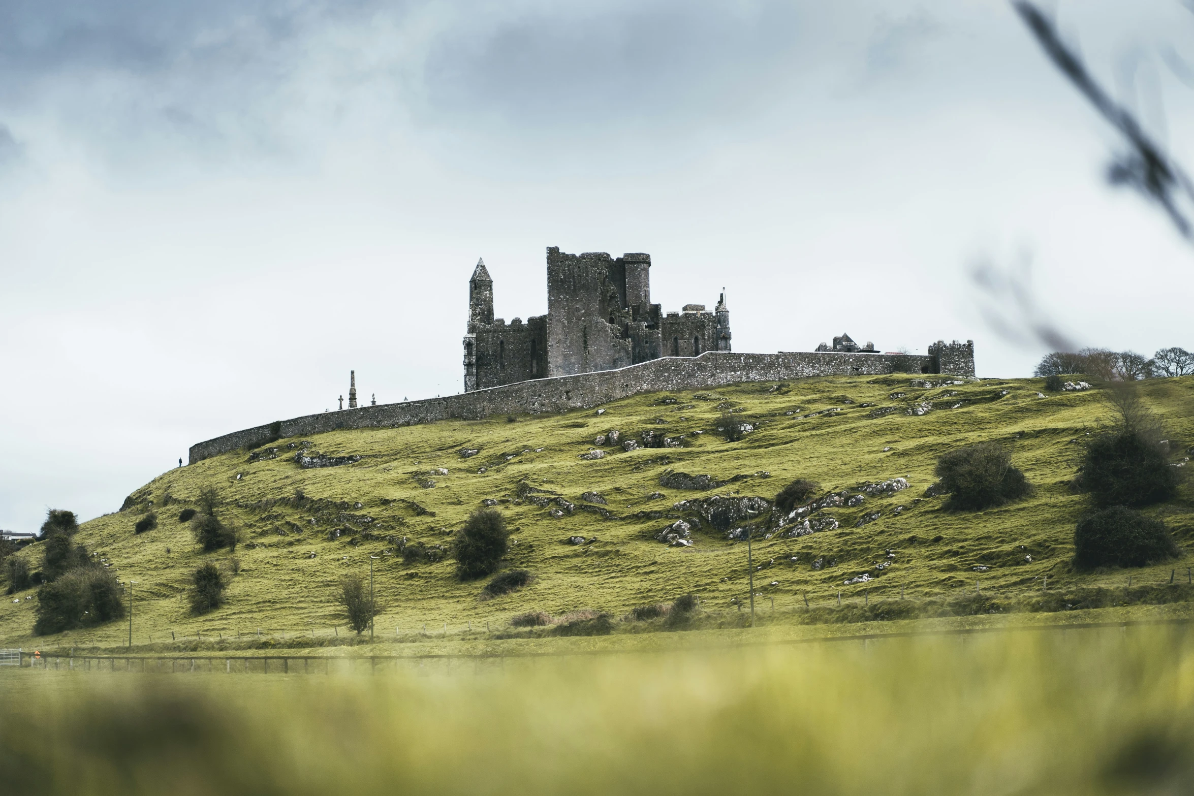 the castle is perched on the hill near the river