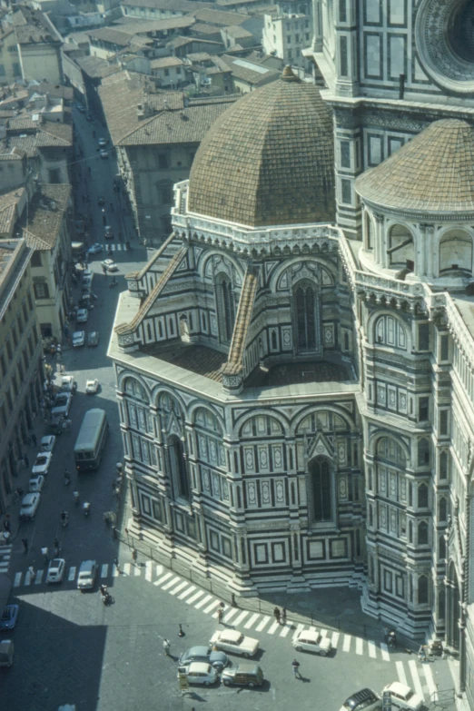 a church with two domes in front of a large cityscape