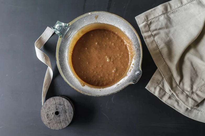 an old style bowl that has a brown substance in it