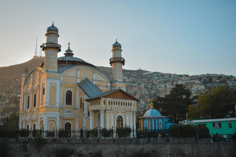 two large, ornate buildings on the side of a hill