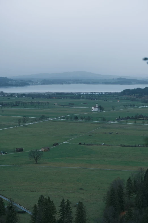 a field that has grass and water in it