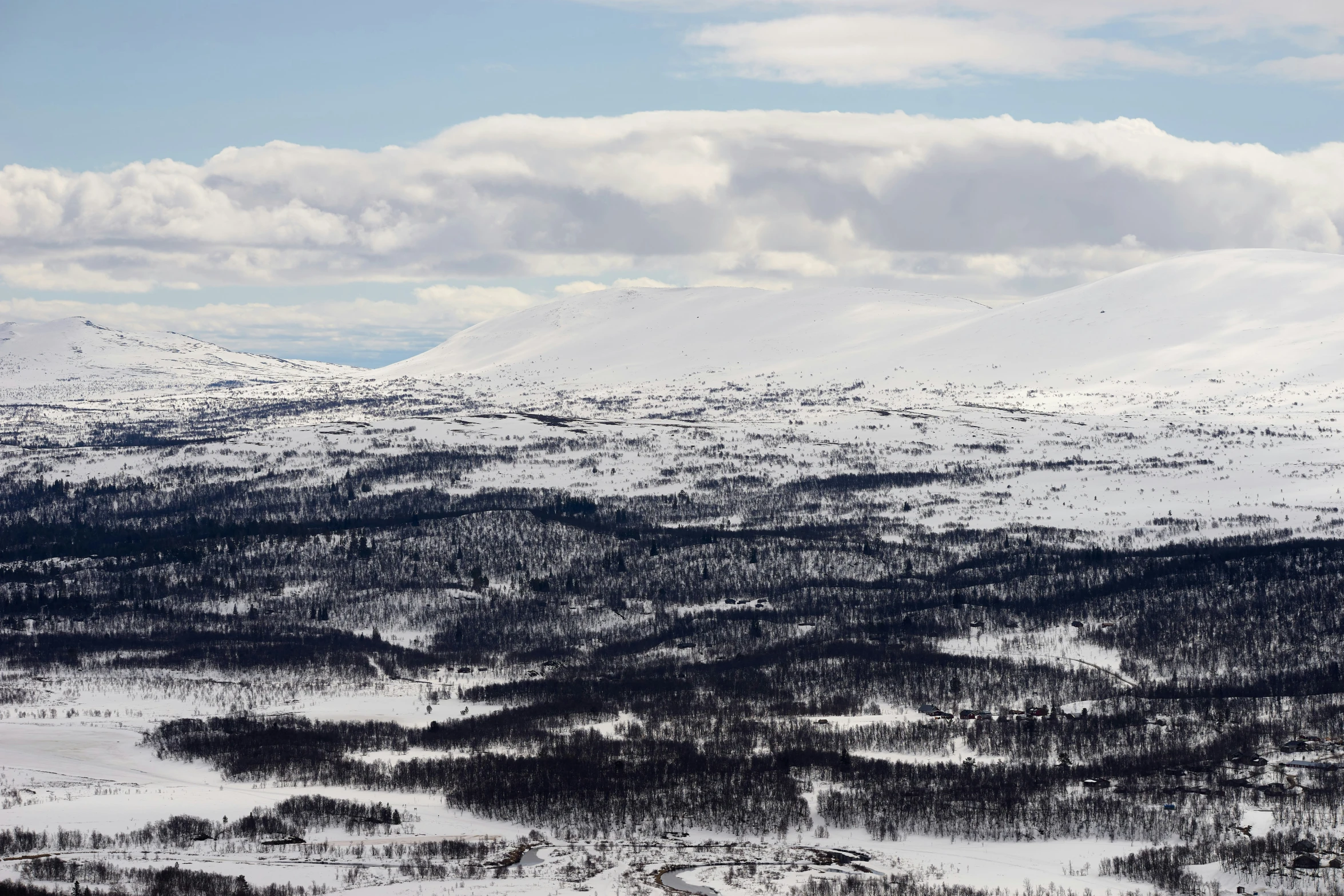 some snowy mountains with clouds in the sky