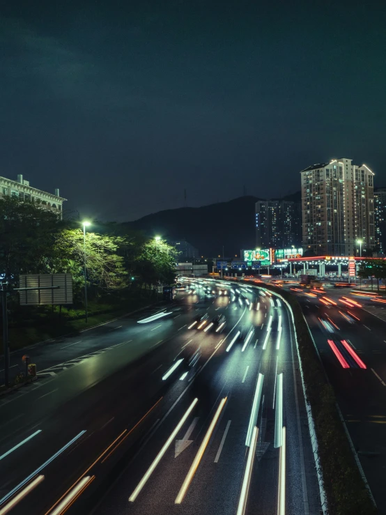 traffic moves along an interstate at night in the city