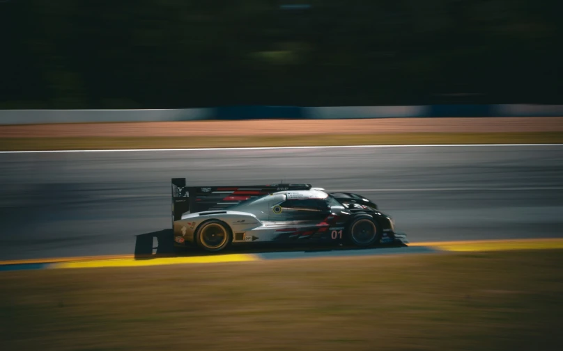 the driver driving the porsche is going fast down the track