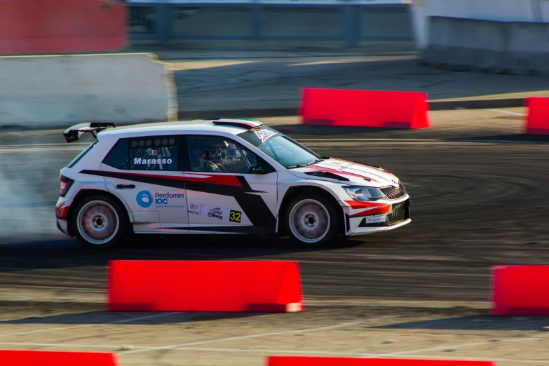 a car going down a dirt track with flames coming out of the back