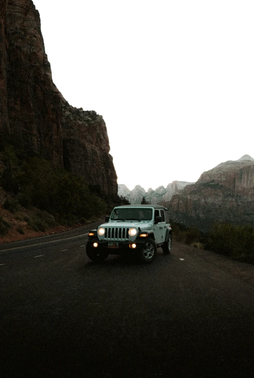 the truck is parked along side the mountains