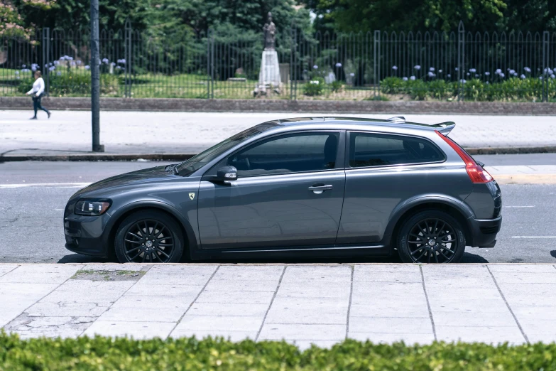 a car with a skateboard on top parked on the side of a road