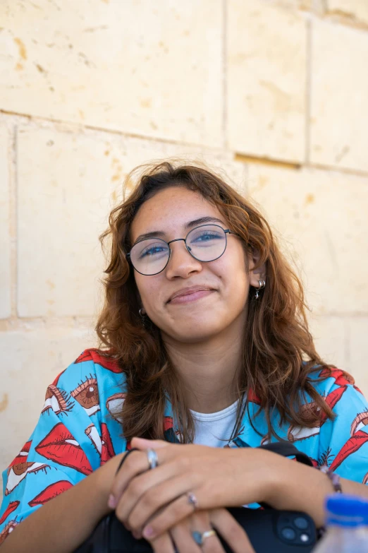 a lady wearing glasses smiling for the camera