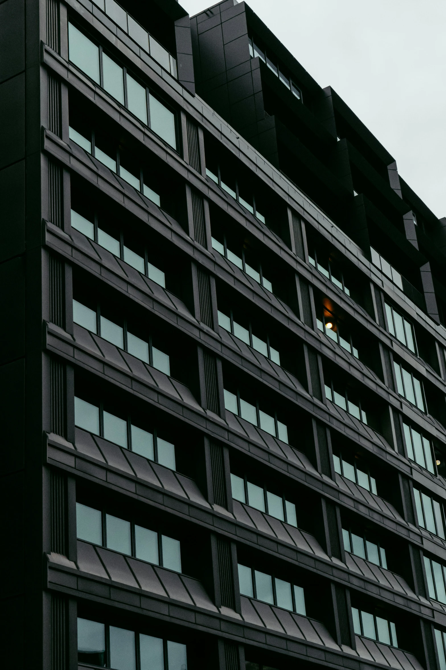 a tall building with lots of windows and traffic lights