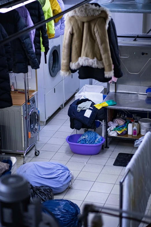 clothing and laundry are hanging out on racks