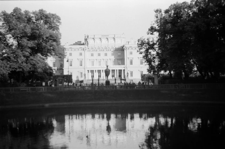 there is a large white house with trees in front of it