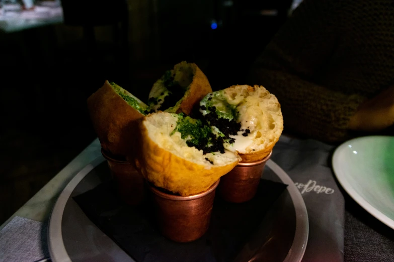 a plate with a muffin on it next to a bowl of food