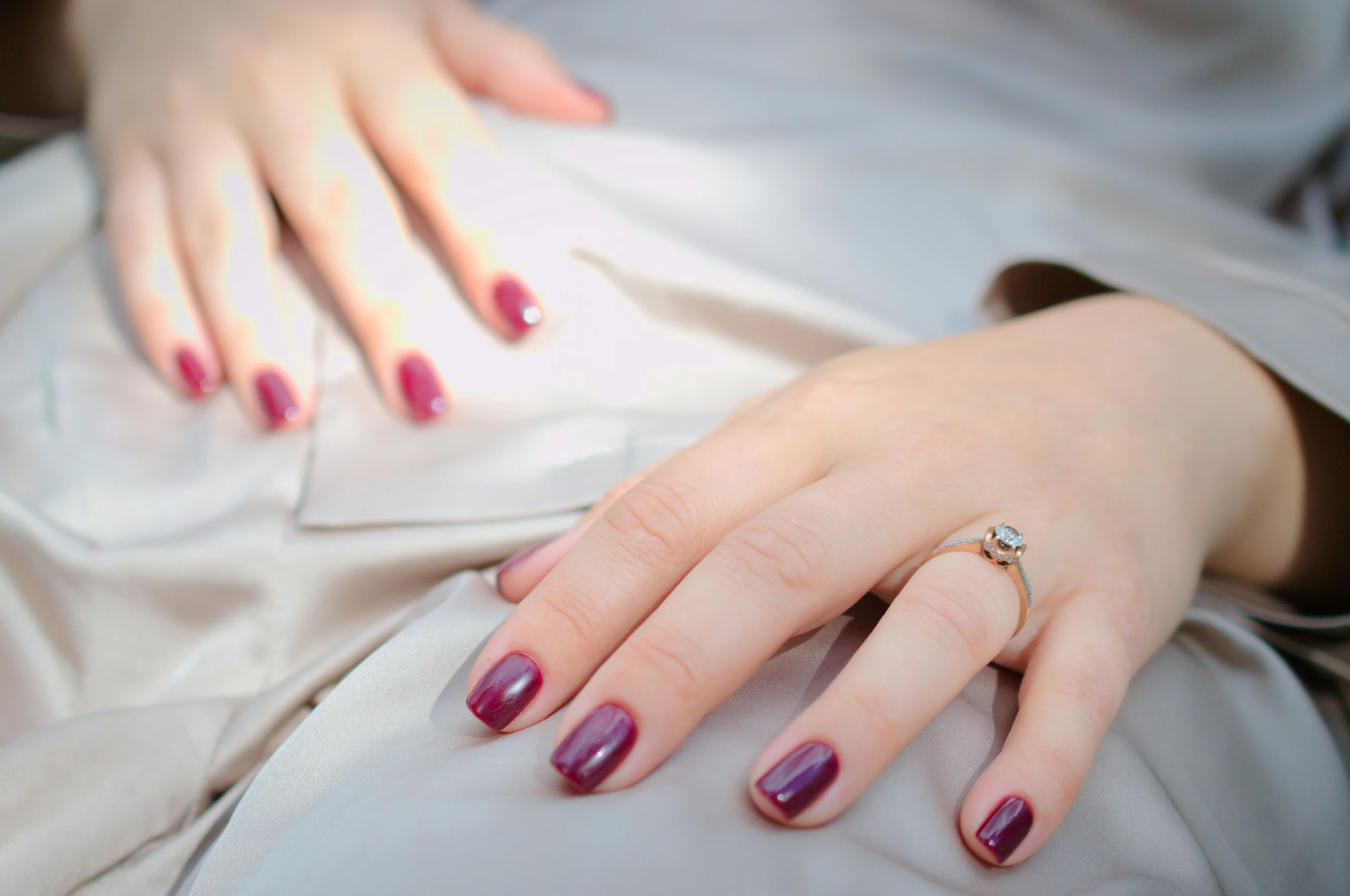 the woman is wearing red and purple fingernails