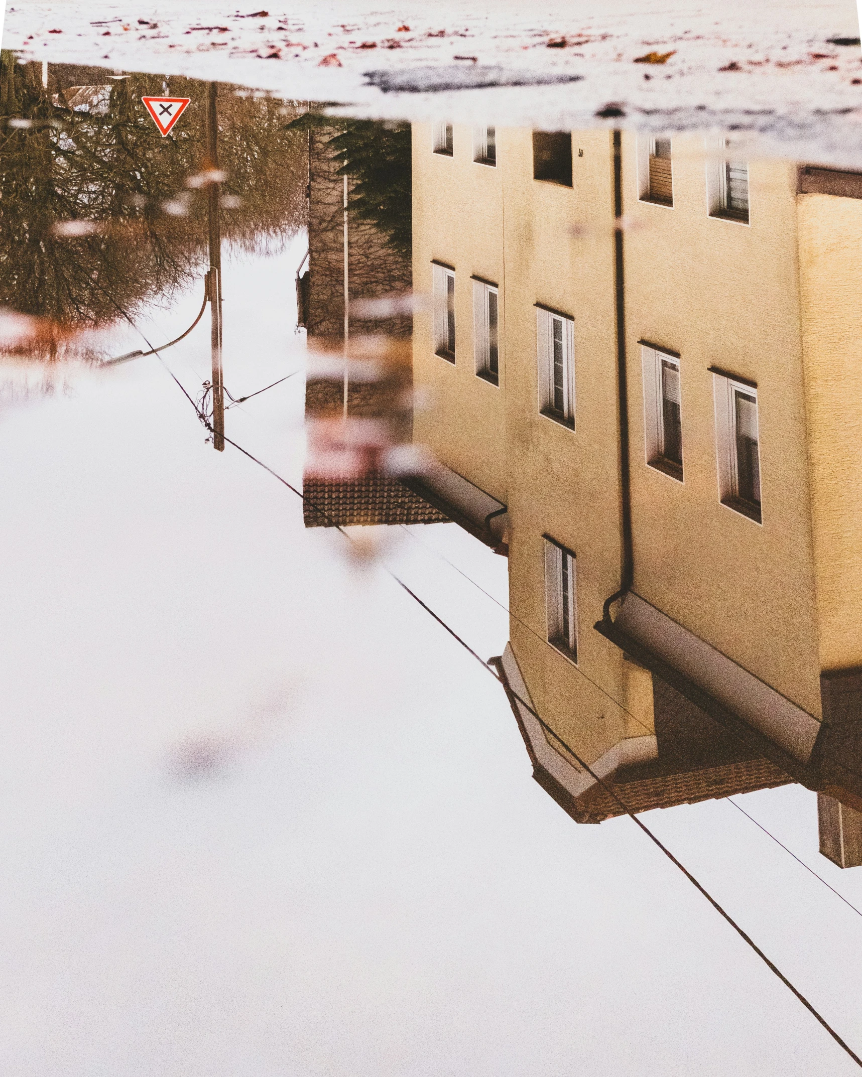 a building is reflected on a surface of water