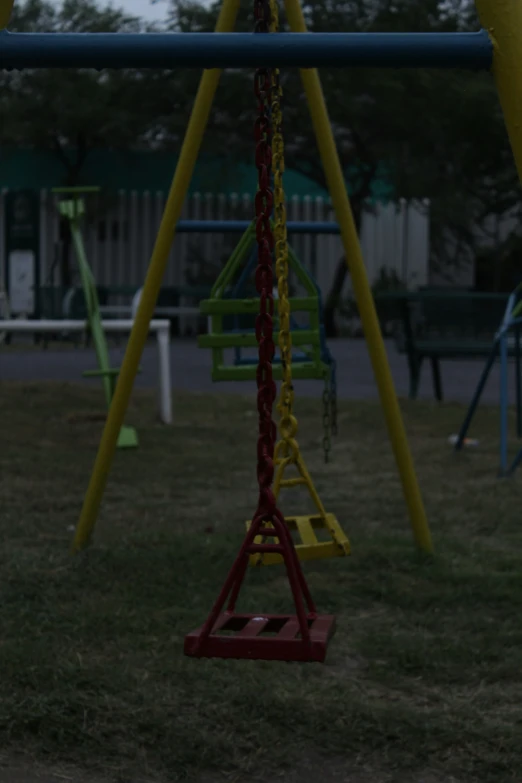 a swing seat hanging over a playground