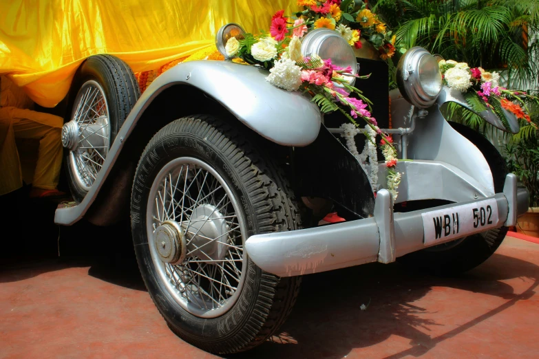 a old time style car with some flowers