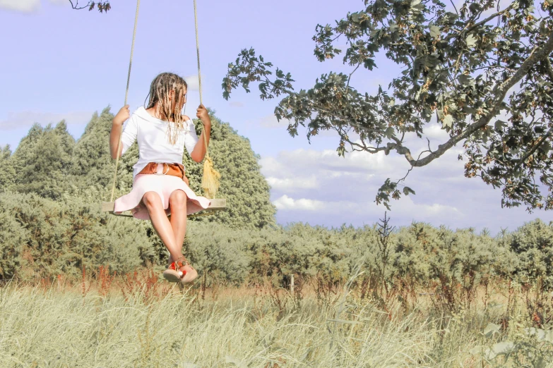 a woman is swinging a wooden swing